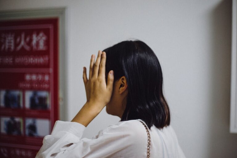 a woman covering her face with her hands