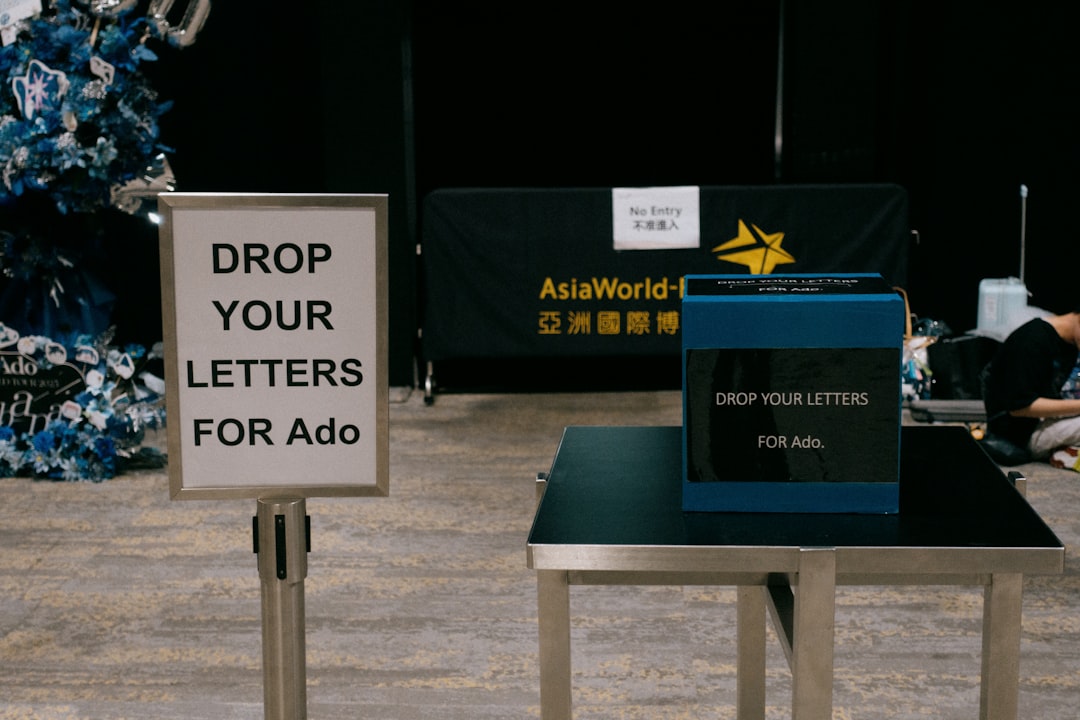 People drop letters for ado in a box.